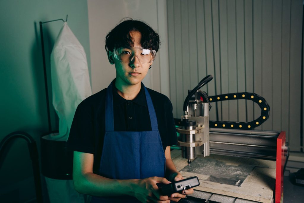 Engineer reviewing a CNC machining setup in a workshop