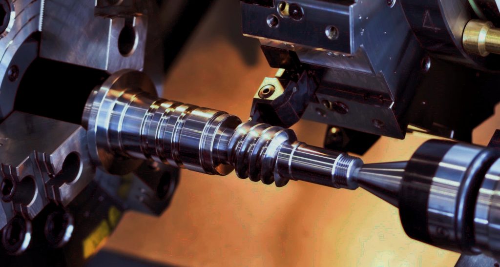 Custom stepped shaft being machined on a CNC turning center